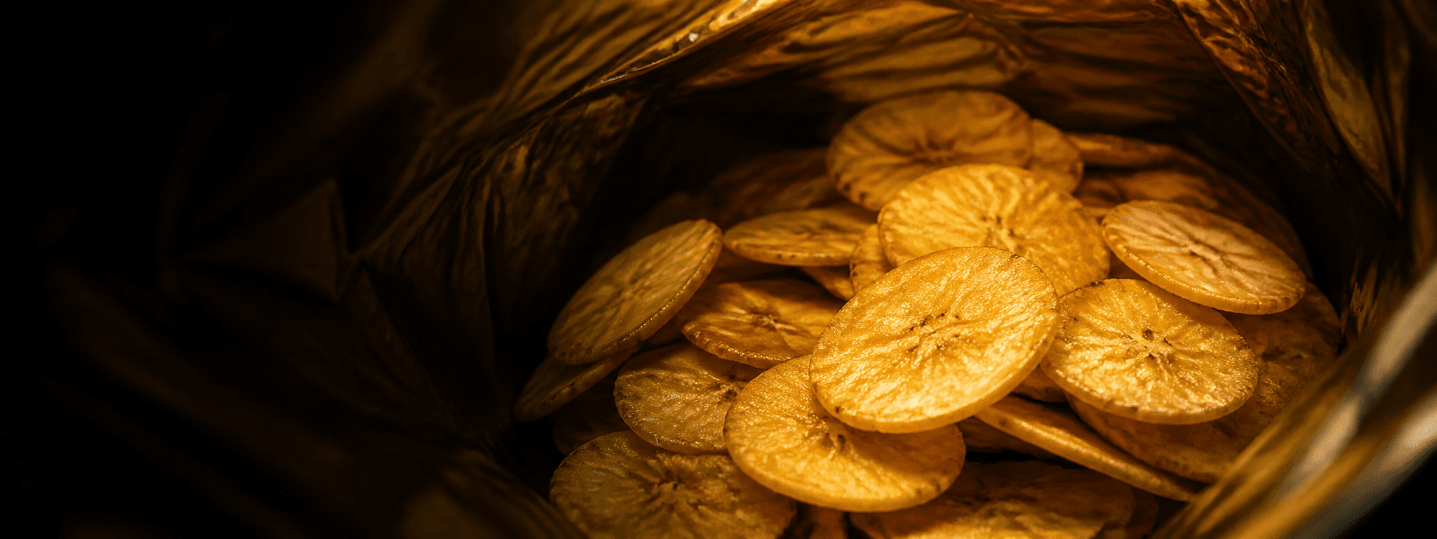 Inside a pouch filled with golden banana chips